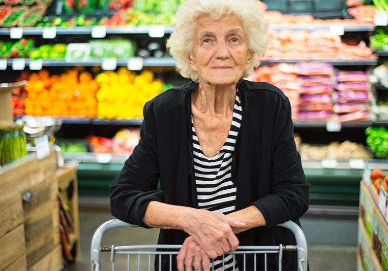 Content senior woman in the grocery store avoiding dementia outbursts in public